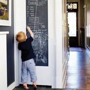 Selbstklebende Kreidetafel an der Wand mit Kreiden